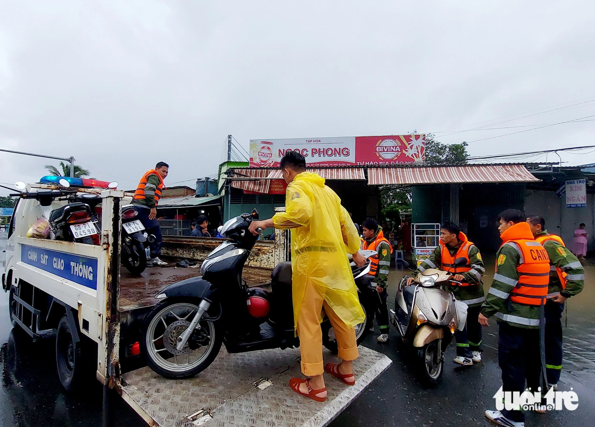 Hơn 60 cán bộ, chiến sĩ công an và lực lượng chức năng địa phương hỗ trợ vận chuyển xe cho người dân về nhà - Ảnh: CHÍ CÔNG